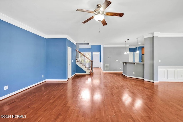 4301 Peeble Dr, Wilmington, NC 28412 - unfurnished living room featuring visible vents, wood finished floors, stairway, ceiling fan, and ornamental molding