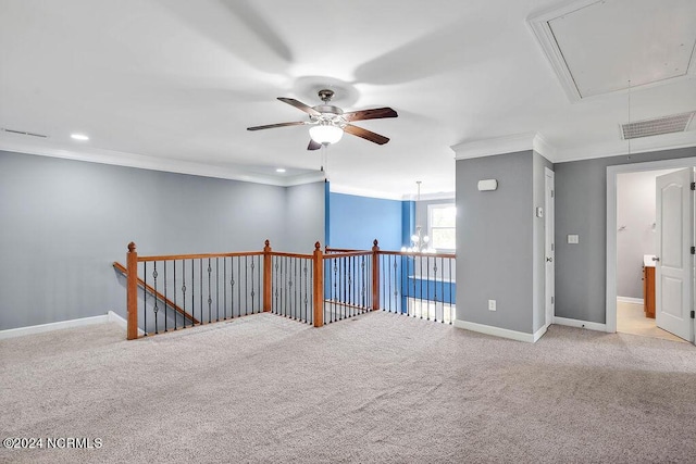 4301 Peeble Dr, Wilmington, NC 28412 - carpeted empty room with visible vents, a ceiling fan, crown molding, baseboards, and attic access