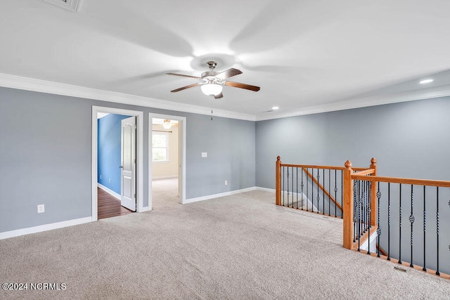 carpeted empty room featuring ceiling fan and crown molding