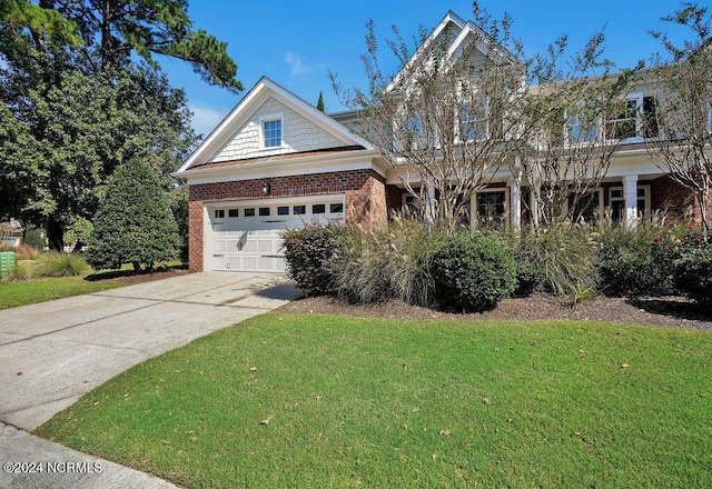 4301 Peeble Dr, Wilmington, NC 28412 - view of front of home with concrete driveway, a front lawn, and brick siding