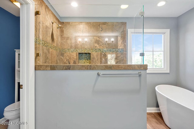 bathroom with toilet, independent shower and bath, and hardwood / wood-style flooring