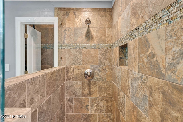 interior details with a tile shower