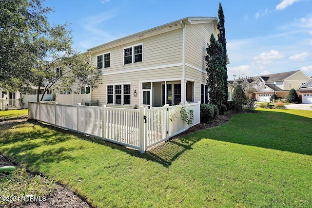 rear view of property with a lawn