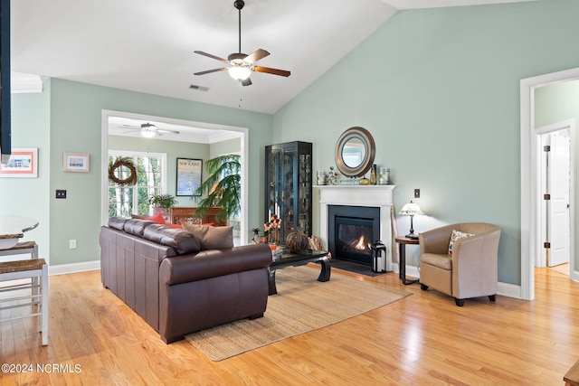 living room featuring high vaulted ceiling, light wood-type flooring, and ceiling fan