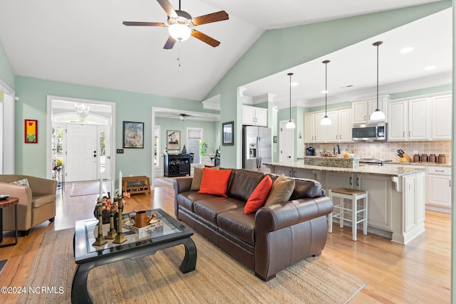 living room featuring light hardwood / wood-style floors, ceiling fan, and high vaulted ceiling