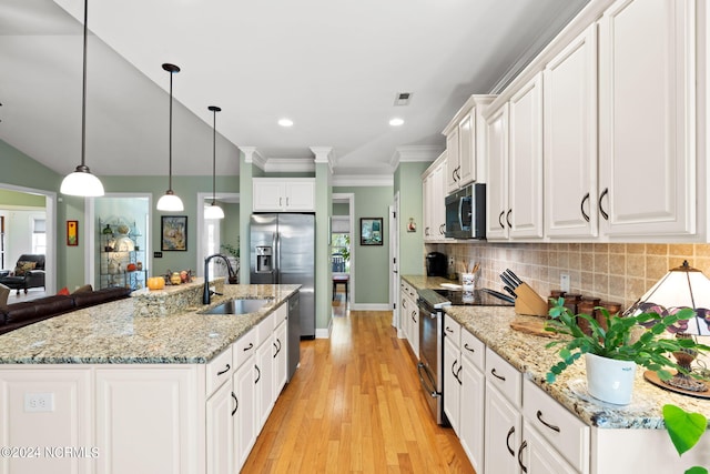 kitchen featuring white cabinetry, pendant lighting, stainless steel appliances, light wood-type flooring, and sink