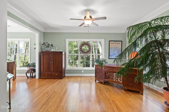 sitting room featuring ceiling fan, ornamental molding, light hardwood / wood-style floors, and a wealth of natural light