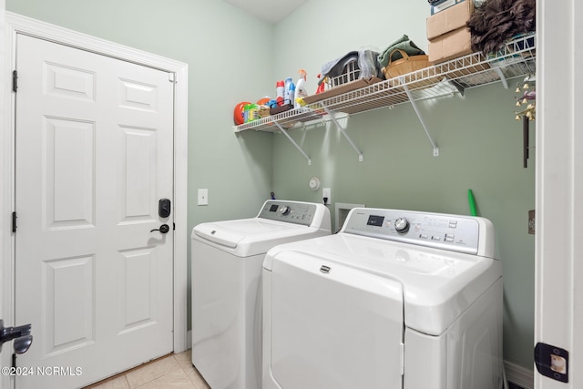 laundry area featuring separate washer and dryer and light tile patterned floors