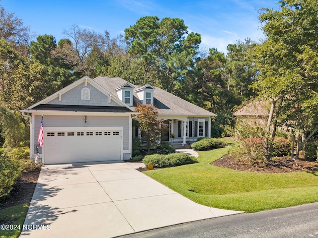 view of front of property featuring a garage and a front lawn