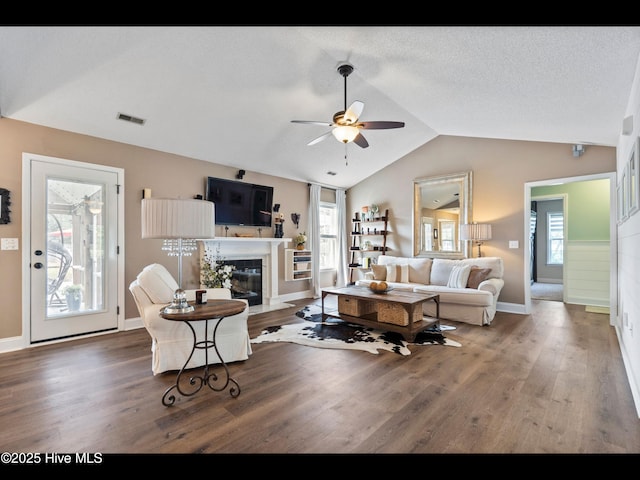 1204 Maple Ridge Rd, Wilmington, NC 28411 - living area with ceiling fan, vaulted ceiling, wood finished floors, and a fireplace with flush hearth