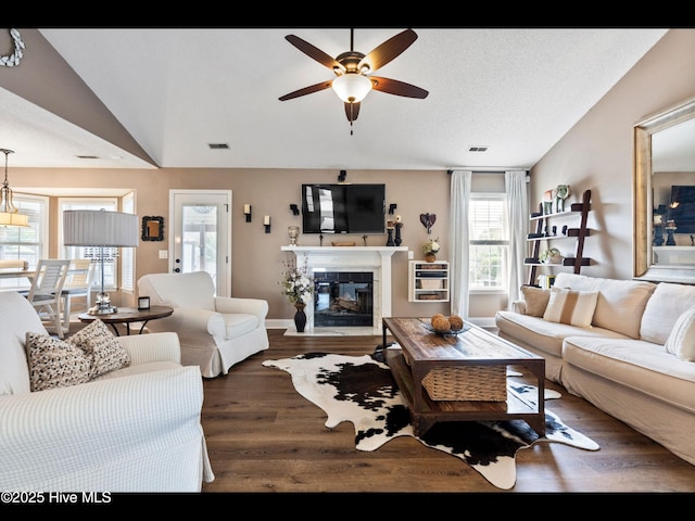 1204 Maple Ridge Rd, Wilmington, NC 28411 - living room featuring a ceiling fan, wood finished floors, a glass covered fireplace, and lofted ceiling