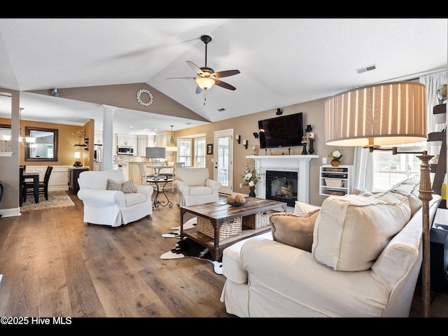 1204 Maple Ridge Rd, Wilmington, NC 28411 - living room with a ceiling fan, decorative columns, a glass covered fireplace, wood finished floors, and lofted ceiling
