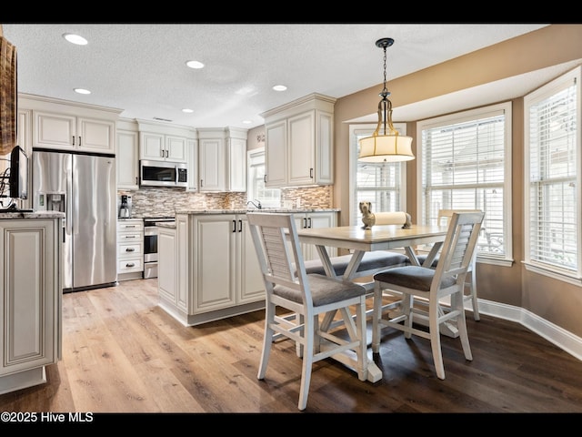 1204 Maple Ridge Rd, Wilmington, NC 28411 - dining space featuring light wood finished floors, recessed lighting, and a textured ceiling