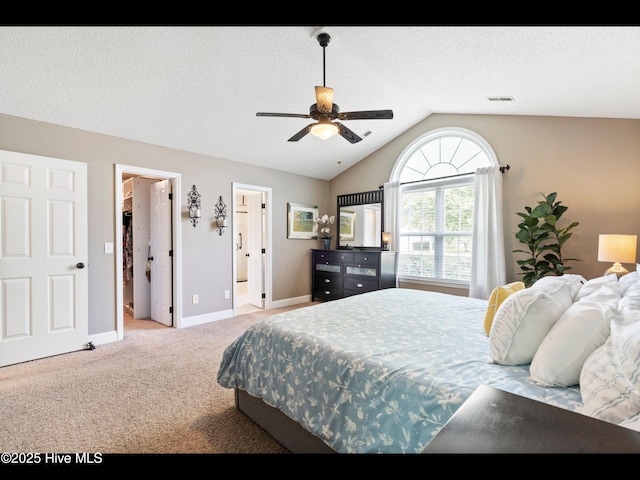 1204 Maple Ridge Rd, Wilmington, NC 28411 - carpeted bedroom featuring lofted ceiling, a walk in closet, a ceiling fan, and ensuite bath