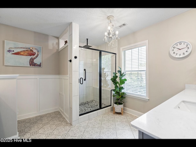 1204 Maple Ridge Rd, Wilmington, NC 28411 - bathroom featuring a chandelier, a shower stall, vanity, and a textured ceiling