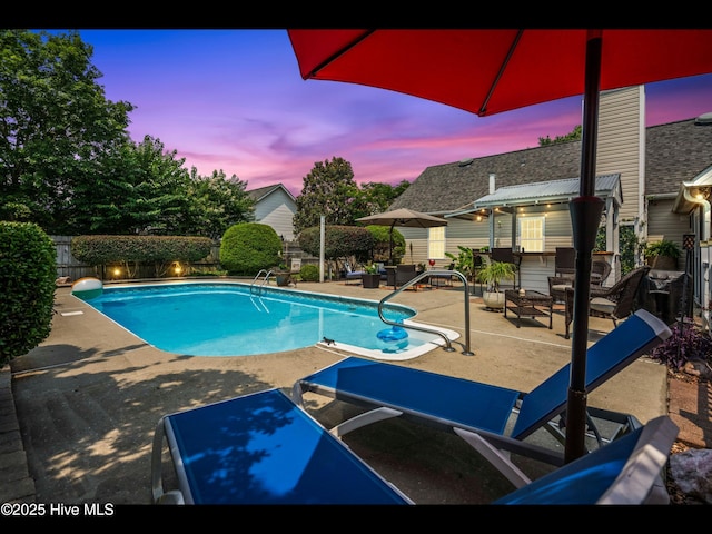 1204 Maple Ridge Rd, Wilmington, NC 28411 - pool at dusk with a patio and a fenced backyard