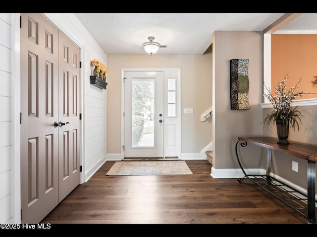 1204 Maple Ridge Rd, Wilmington, NC 28411 - entryway featuring dark wood finished floors, a textured ceiling, and stairs