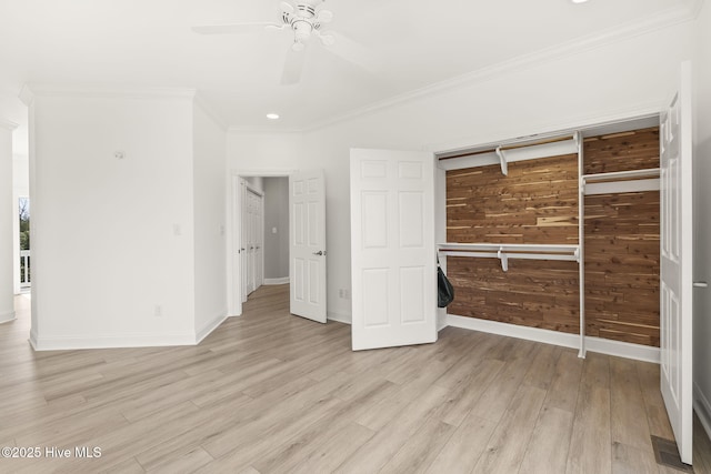 10002 Coast Guard Rd, Emerald Isle, NC 28594 - unfurnished bedroom featuring light wood-style flooring, ornamental molding, baseboards, a ceiling fan, and wood walls