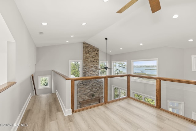 10002 Coast Guard Rd, Emerald Isle, NC 28594 - hall with an upstairs landing, healthy amount of natural light, recessed lighting, wood finished floors, and high vaulted ceiling