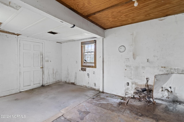 unfurnished room with wood ceiling