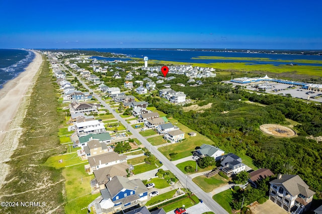 bird's eye view featuring a water view and a beach view