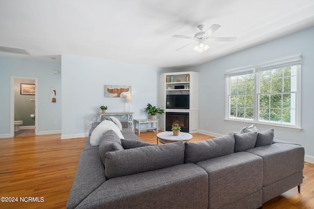 living room featuring light hardwood / wood-style floors and ceiling fan