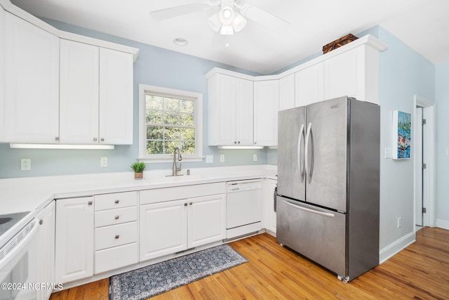 kitchen featuring white cabinetry, sink, white appliances, and light hardwood / wood-style flooring