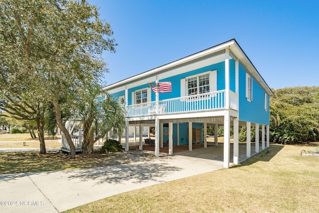 beach home with a carport and a front lawn