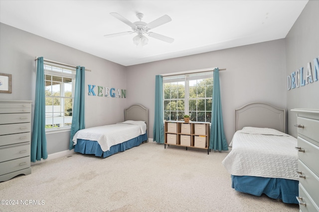 bedroom featuring light carpet and ceiling fan