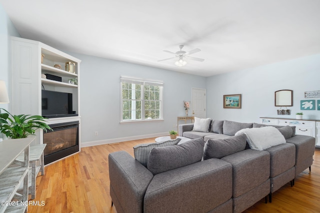 living room with ceiling fan and light hardwood / wood-style floors