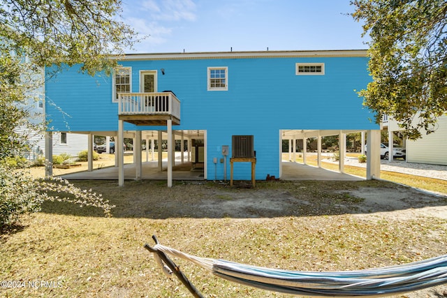 back of property with a carport