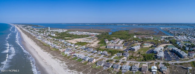 drone / aerial view featuring a water view and a beach view