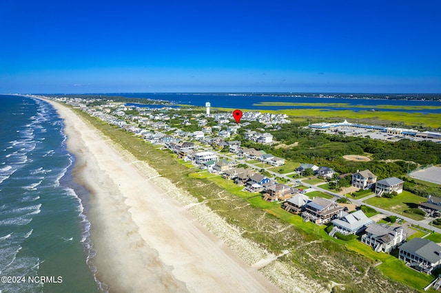 drone / aerial view featuring a water view and a beach view