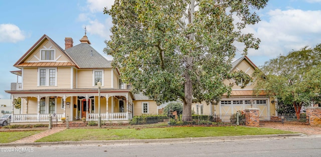 view of front of property with a garage and covered porch