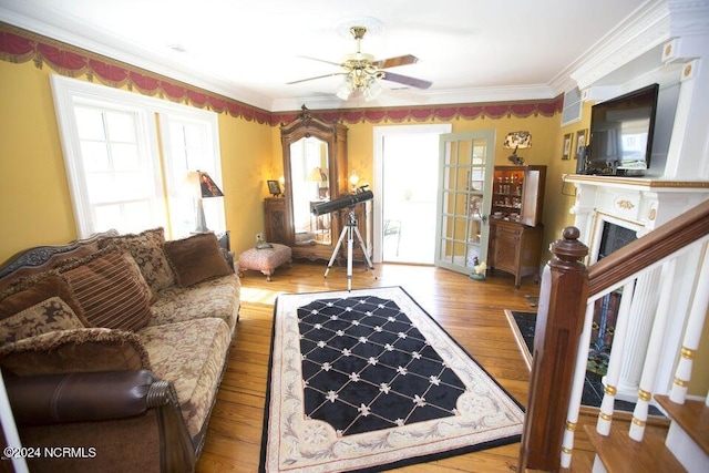 living room with ceiling fan, light hardwood / wood-style flooring, and ornamental molding