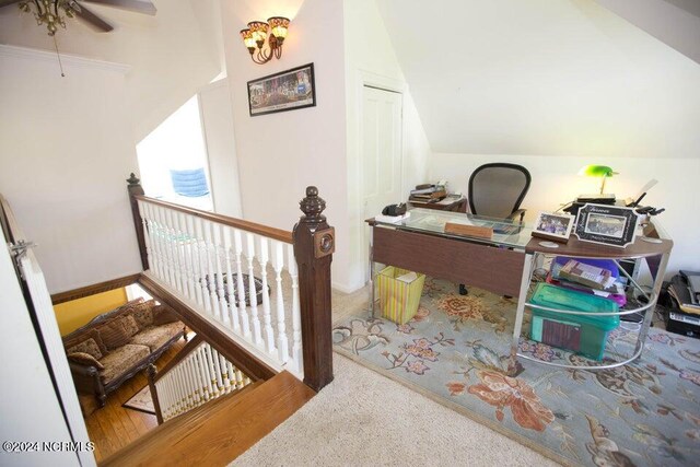 home office with ceiling fan, wood-type flooring, and lofted ceiling