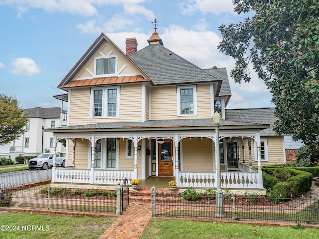 victorian house featuring a porch