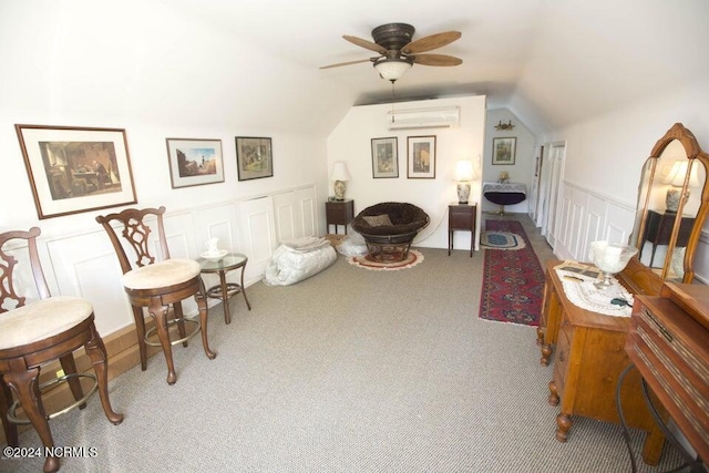 carpeted office space featuring vaulted ceiling, a wall mounted AC, and ceiling fan