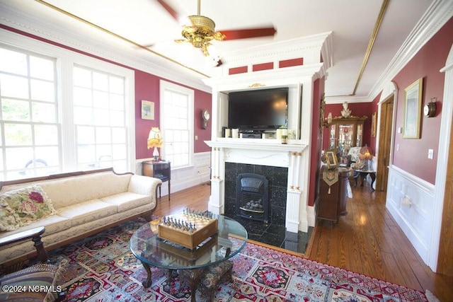 living room featuring crown molding, dark hardwood / wood-style flooring, and ceiling fan