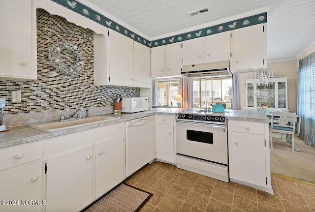 kitchen with sink, plenty of natural light, white appliances, and white cabinetry