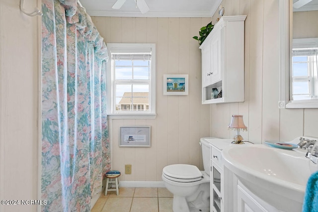 bathroom with tile patterned floors, a healthy amount of sunlight, vanity, and toilet