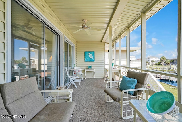 sunroom / solarium featuring ceiling fan