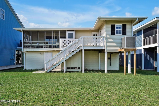 back of property featuring a yard and a sunroom