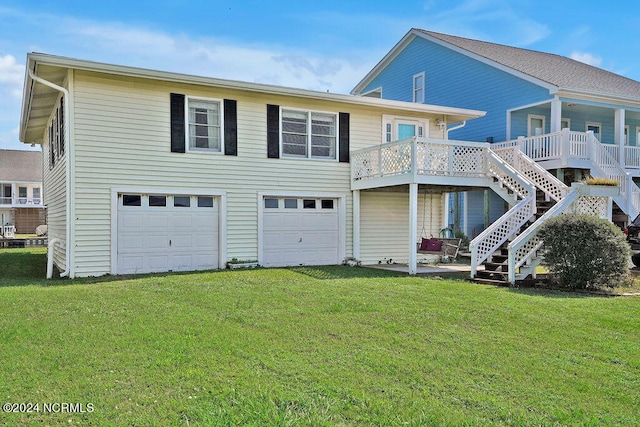 back of house with a garage, a wooden deck, and a lawn