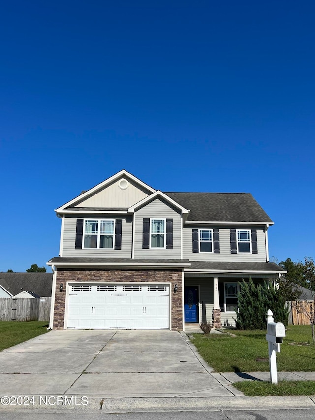 view of front of house featuring a garage and a front yard