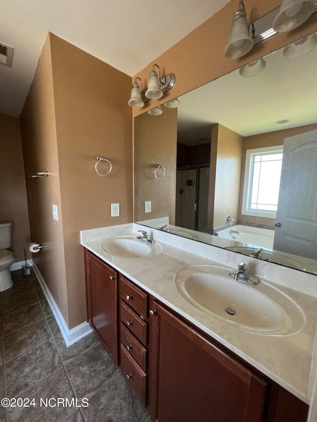 full bathroom featuring independent shower and bath, vanity, toilet, and tile patterned floors