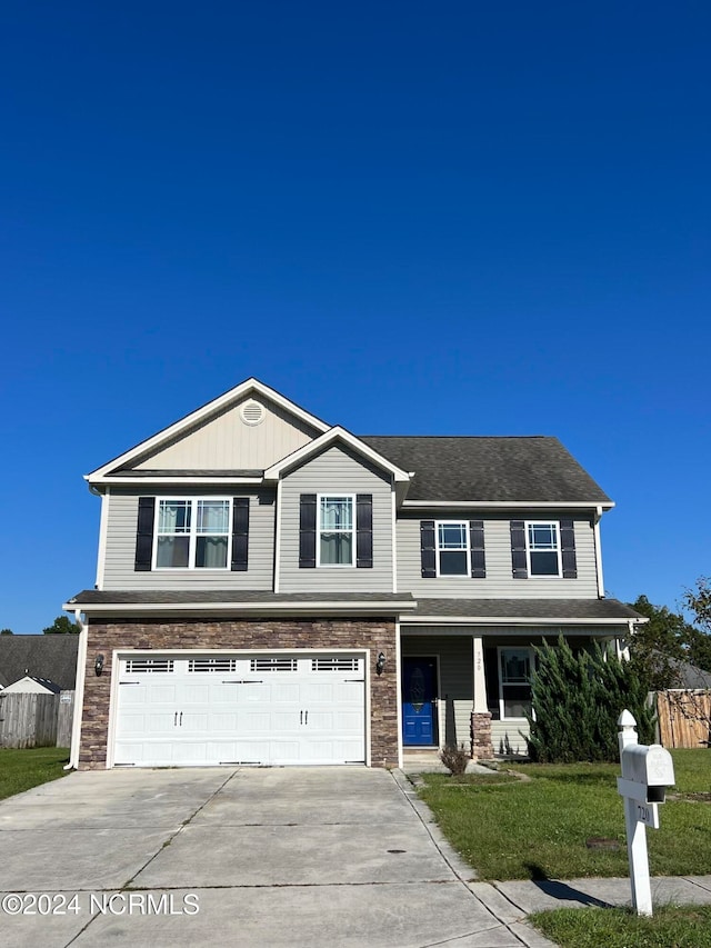 view of front of house with a garage and a front yard