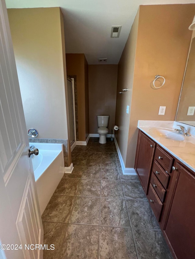 full bathroom featuring tile patterned flooring, shower with separate bathtub, vanity, and toilet