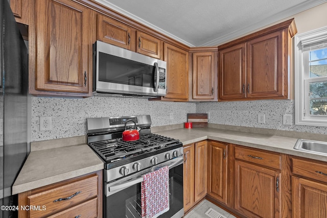 kitchen with a textured ceiling and appliances with stainless steel finishes