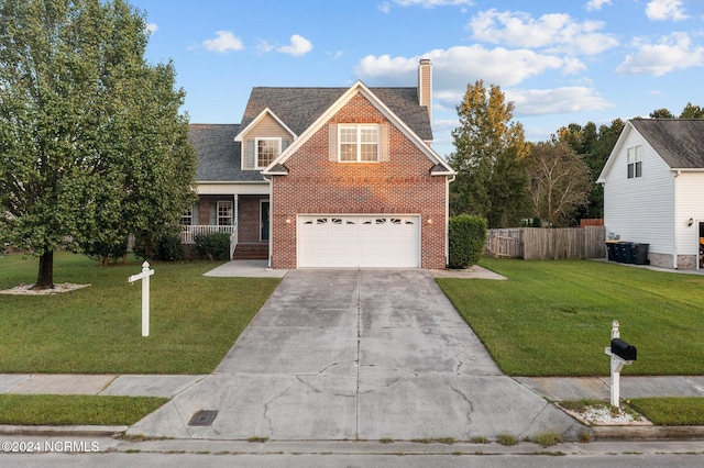 view of front of property featuring a front lawn and a garage